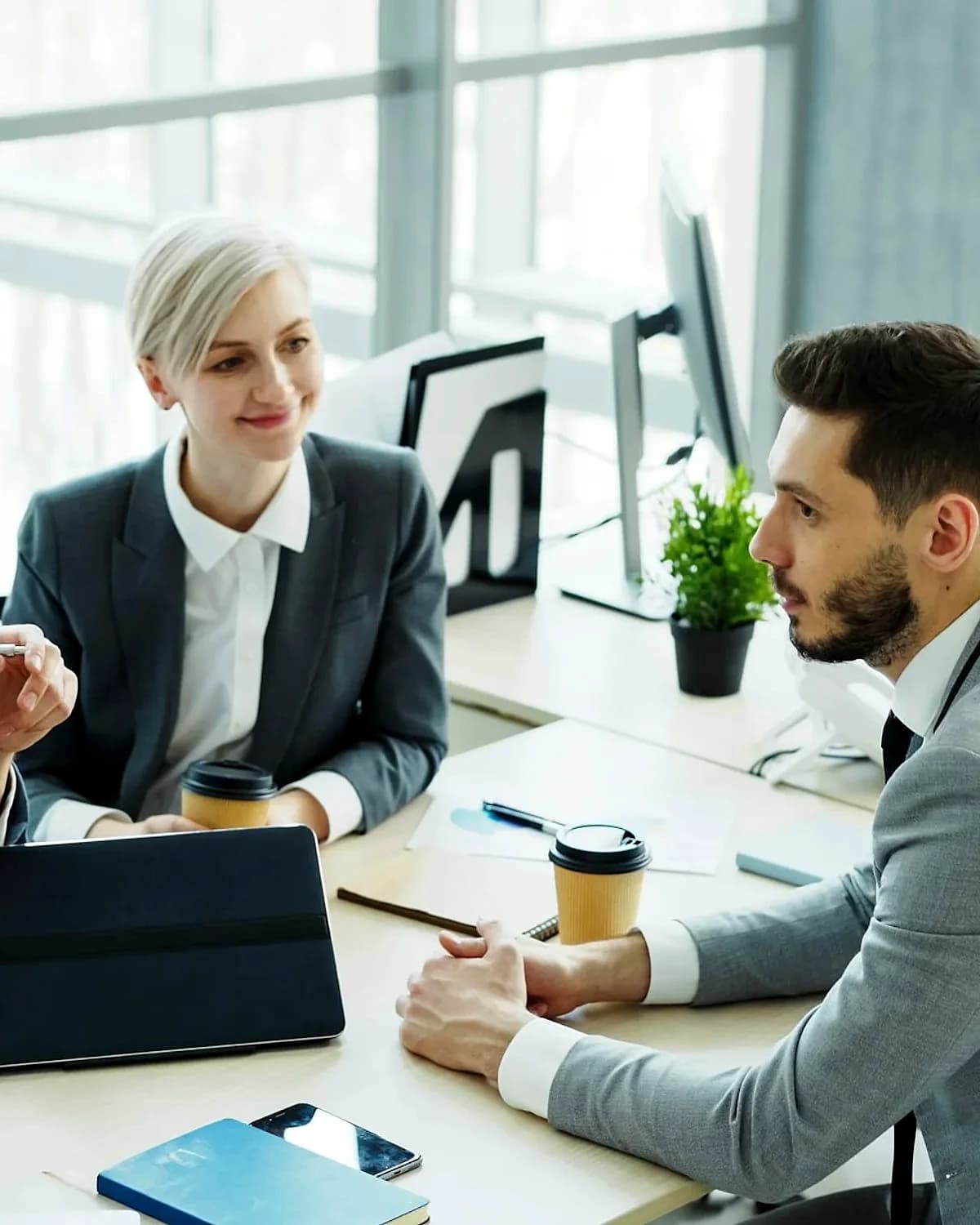 A business team meeting around a table in a modern office