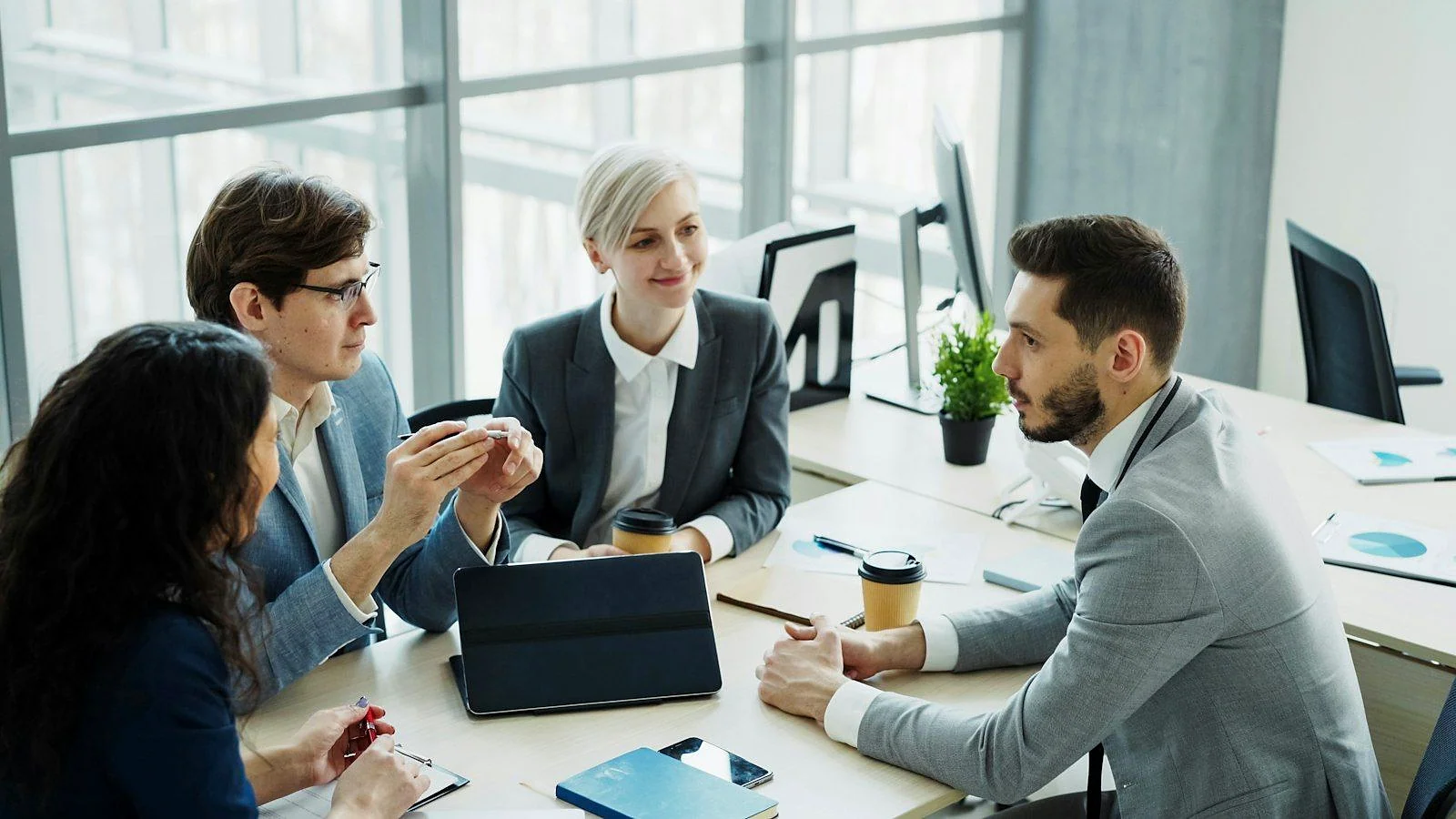 A diverse management team collaborating around a table in a modern office